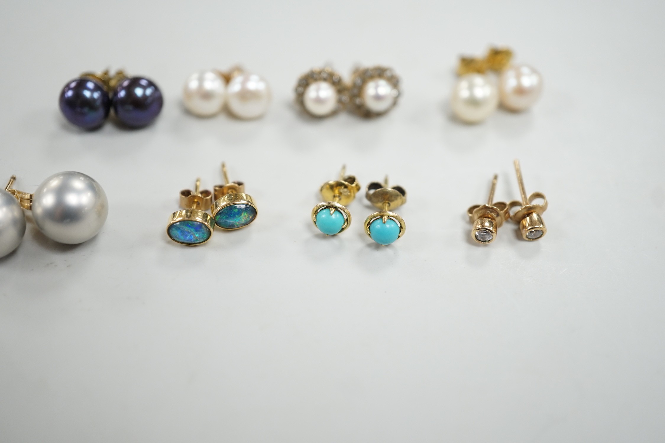Eight assorted modern pairs of ear studs, including a 14k and cultured pearl and two other cultured pearl, one 9ct and diamond chip.